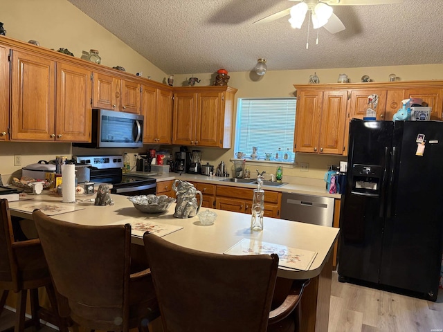 301 Halteria Ln Unit A, B, C, D, E, Hot Springs, AR 71913 - kitchen with a kitchen breakfast bar, light countertops, a ceiling fan, a textured ceiling, and appliances with stainless steel finishes