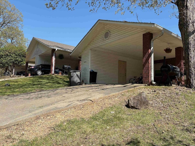 301 Halteria Ln Unit A, B, C, D, E, Hot Springs, AR 71913 - view of side of property featuring a yard, driveway, and an attached carport
