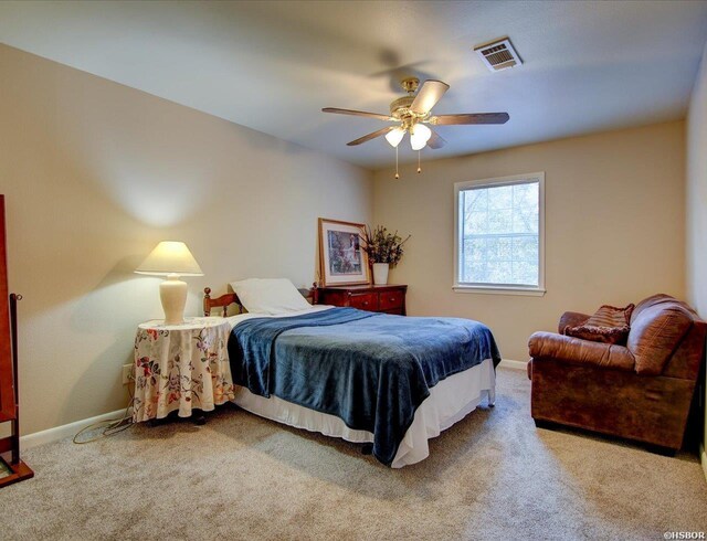 bedroom featuring a ceiling fan, carpet, visible vents, and baseboards