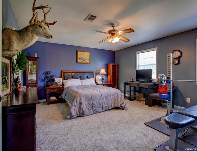 bedroom featuring carpet floors, a ceiling fan, visible vents, and baseboards