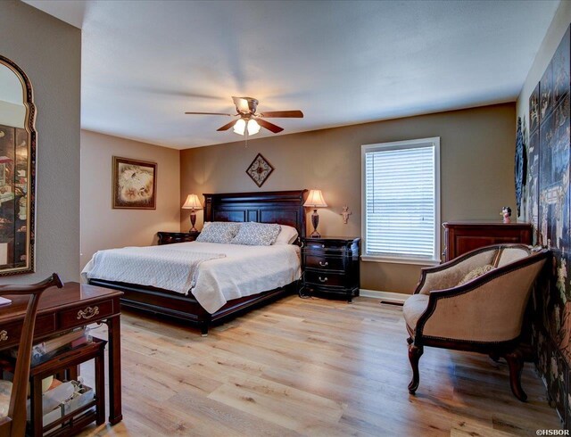 bedroom featuring ceiling fan, light wood finished floors, and baseboards