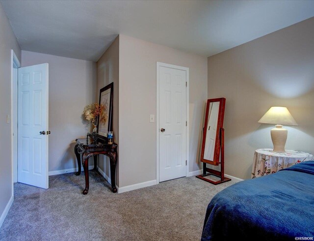 carpeted bedroom with baseboards