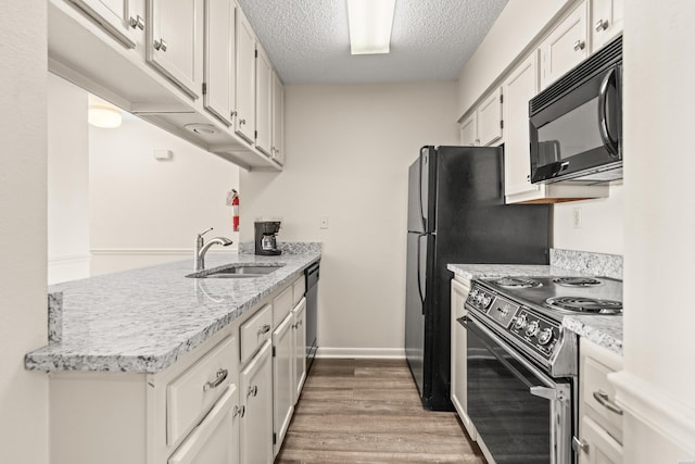 5371 Central Ave Unit 5L, Hot Springs, AR 71913 - kitchen featuring black microwave, electric stove, a peninsula, a textured ceiling, and light wood-style flooring