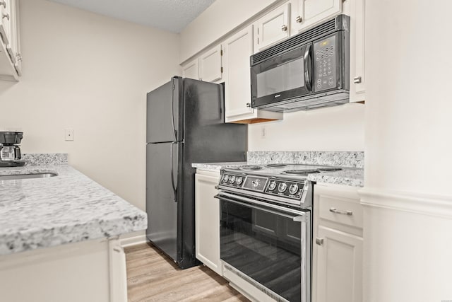 5371 Central Ave Unit 5L, Hot Springs, AR 71913 - kitchen featuring black appliances, light wood finished floors, white cabinets, and light stone countertops