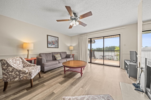 5371 Central Ave Unit 5L, Hot Springs, AR 71913 - living room with a textured ceiling, light wood-style flooring, and a ceiling fan