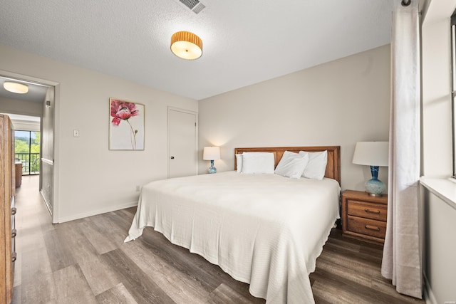 5371 Central Ave Unit 5L, Hot Springs, AR 71913 - bedroom featuring wood finished floors and a textured ceiling