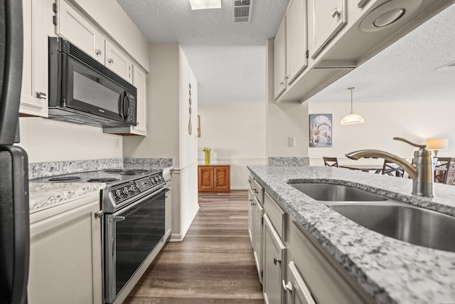 5371 Central Ave Unit 5L, Hot Springs, AR 71913 - kitchen with stainless steel electric range oven, black microwave, a textured ceiling, dark wood-style flooring, and white cabinets