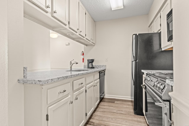 5371 Central Ave Unit 5L, Hot Springs, AR 71913 - kitchen with stainless steel appliances, a textured ceiling, light wood-style floors, white cabinetry, and a peninsula