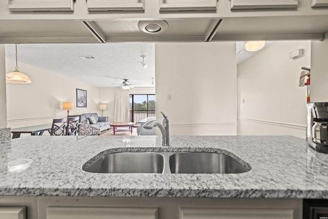 5371 Central Ave Unit 5L, Hot Springs, AR 71913 - kitchen featuring light stone countertops, a ceiling fan, hanging light fixtures, open floor plan, and a textured ceiling