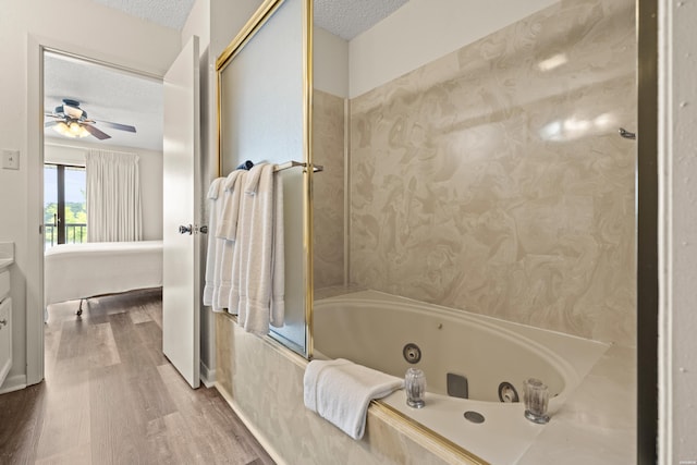 5371 Central Ave Unit 5L, Hot Springs, AR 71913 - bathroom featuring a tub with jets, wood finished floors, a textured ceiling, a ceiling fan, and ensuite bathroom