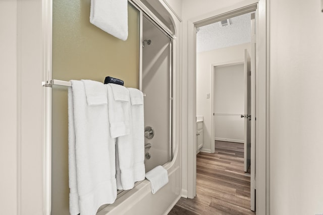 5371 Central Ave Unit 5L, Hot Springs, AR 71913 - bathroom with wood finished floors, a textured ceiling, and bathtub / shower combination