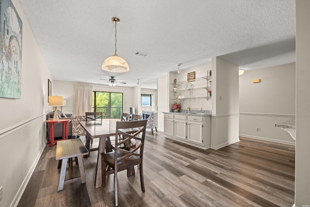 5371 Central Ave Unit 5L, Hot Springs, AR 71913 - dining area featuring a textured ceiling, dark wood-style flooring, and a ceiling fan