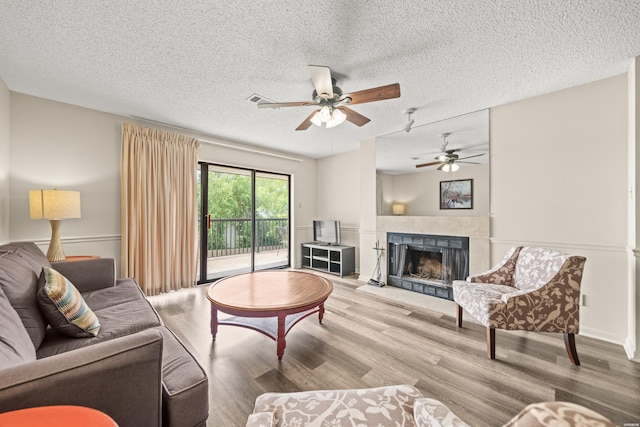 5371 Central Ave Unit 5L, Hot Springs, AR 71913 - living area featuring a textured ceiling, wood finished floors, ceiling fan, and a fireplace