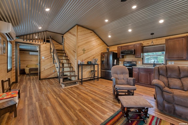 152 Anderson Loop, Amity, AR 71921 - living room featuring lofted ceiling, light wood-style flooring, wood walls, wood ceiling, and stairway
