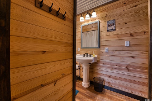 152 Anderson Loop, Amity, AR 71921 - bathroom featuring wood walls and wood finished floors