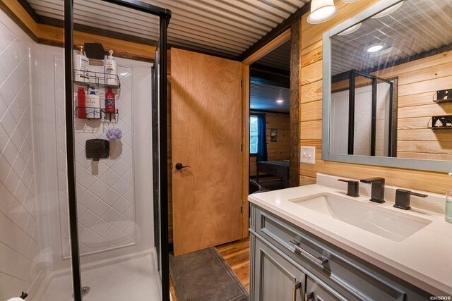 152 Anderson Loop, Amity, AR 71921 - full bath with a stall shower, vanity, wooden walls, and wood finished floors