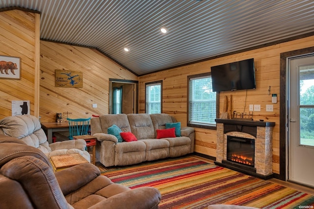 152 Anderson Loop, Amity, AR 71921 - living room featuring vaulted ceiling, wooden walls, and a stone fireplace