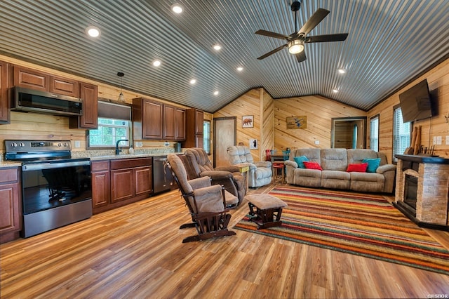 152 Anderson Loop, Amity, AR 71921 - living area featuring wooden walls, vaulted ceiling, light wood-style floors, a ceiling fan, and recessed lighting