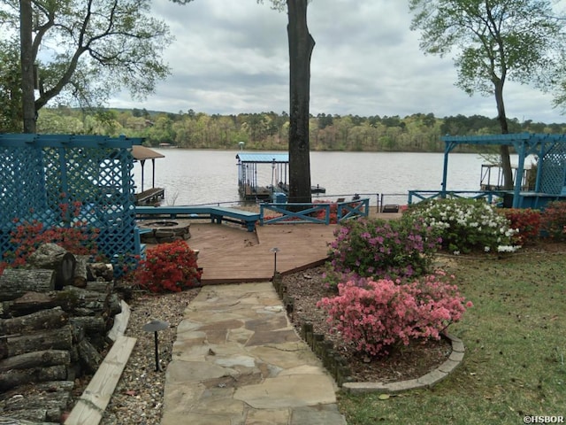 view of dock featuring a water view and a wooded view
