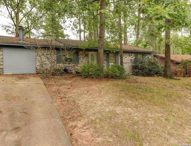 ranch-style house with brick siding, driveway, and an attached garage