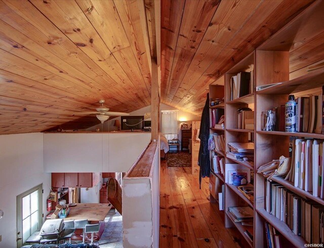 corridor with lofted ceiling, wooden ceiling, wood finished floors, and an upstairs landing