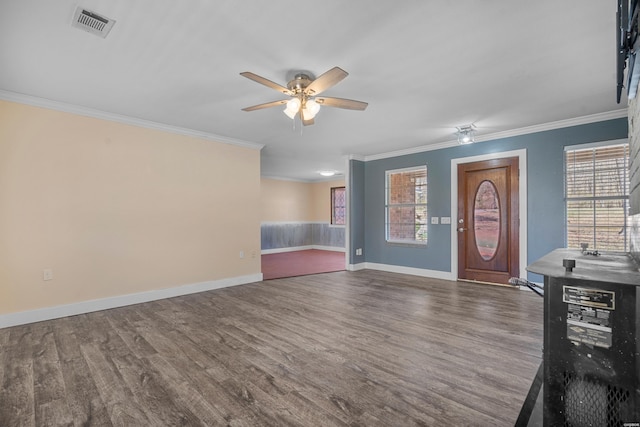 entryway with a ceiling fan, baseboards, visible vents, ornamental molding, and dark wood-type flooring