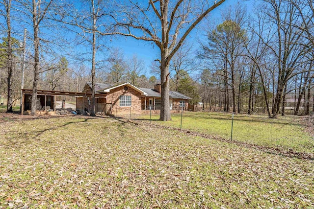 view of front of home featuring a chimney, a front lawn, and fence