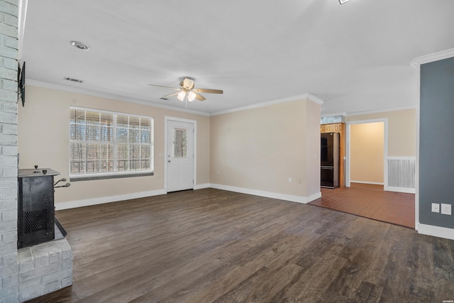 unfurnished living room with a ceiling fan, dark wood-style floors, visible vents, a fireplace, and ornamental molding