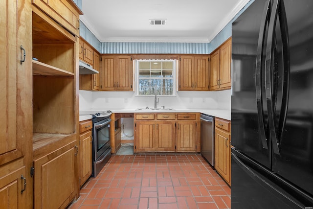 kitchen featuring a sink, under cabinet range hood, stainless steel appliances, crown molding, and brick floor