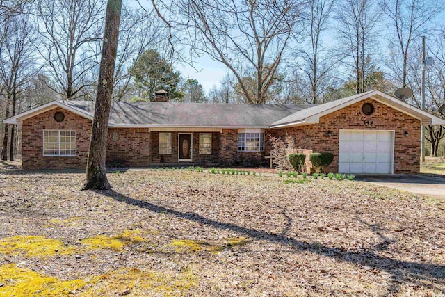 single story home featuring a garage, brick siding, driveway, and a chimney