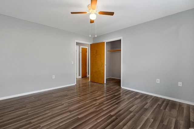 unfurnished bedroom featuring a closet, a ceiling fan, baseboards, and dark wood-style flooring