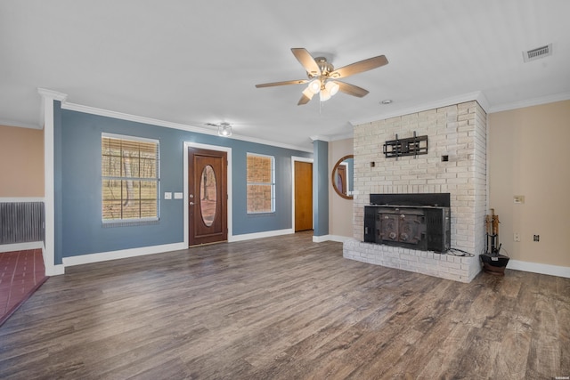 unfurnished living room with wood finished floors, visible vents, baseboards, a fireplace, and ornamental molding