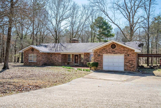 ranch-style home featuring driveway, an attached garage, a shingled roof, brick siding, and a chimney