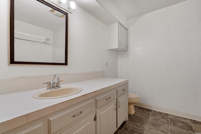 full bathroom with toilet and vanity