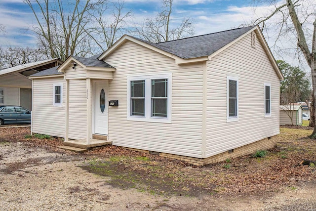 bungalow-style house featuring a shingled roof and crawl space