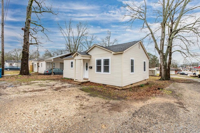 bungalow-style home featuring a shingled roof and crawl space