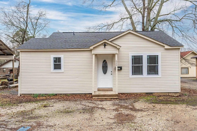 bungalow-style house featuring crawl space and roof with shingles