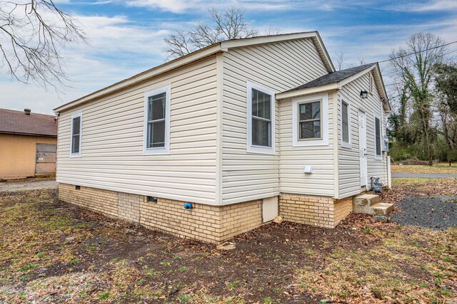 view of side of property with crawl space