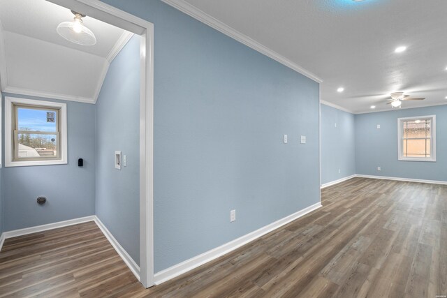 interior space featuring recessed lighting, dark wood-type flooring, a ceiling fan, baseboards, and crown molding