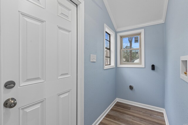 washroom with laundry area, baseboards, dark wood-type flooring, crown molding, and hookup for an electric dryer