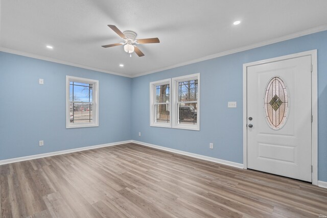 entryway with baseboards, ornamental molding, and a healthy amount of sunlight