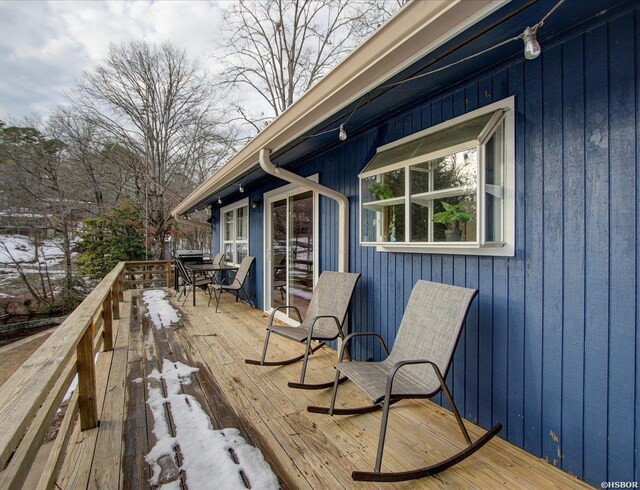 wooden terrace with outdoor dining space