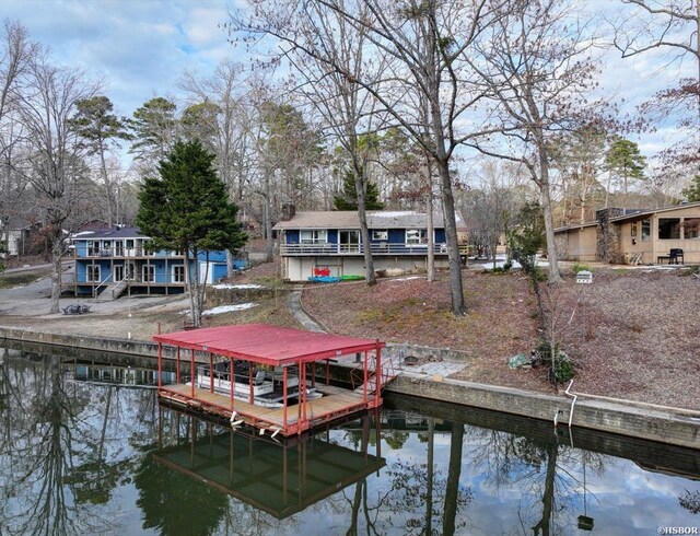 dock area with a residential view, a water view, and boat lift