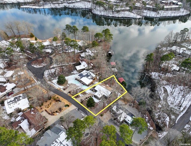 snowy aerial view featuring a water view