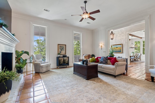 498 Lantern Ter, Hot Springs, AR 71913 - living room featuring a fireplace, crown molding, light tile patterned floors, ceiling fan, and baseboards