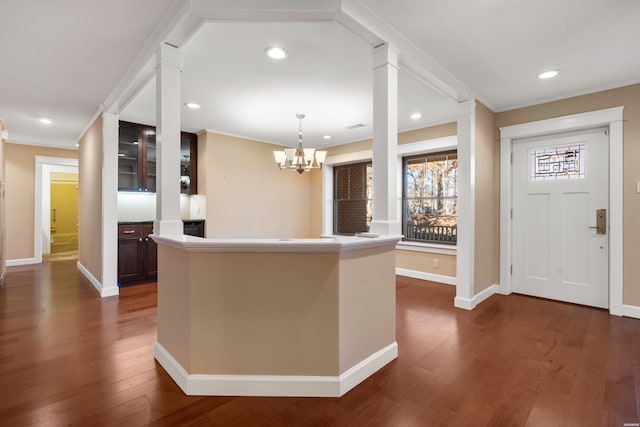 foyer entrance with dark wood-type flooring, recessed lighting, crown molding, and baseboards