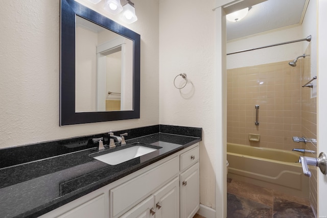 full bath featuring toilet, a textured wall, shower / bathing tub combination, and vanity