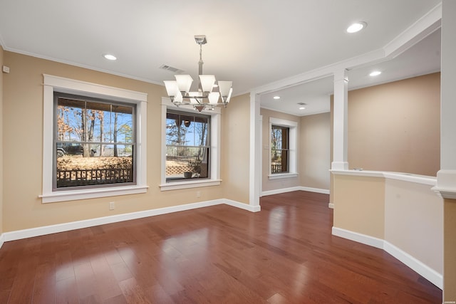 unfurnished dining area with baseboards, visible vents, ornamental molding, wood finished floors, and recessed lighting