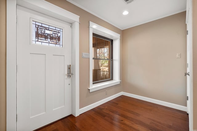 entrance foyer with recessed lighting, dark wood-type flooring, visible vents, baseboards, and ornamental molding