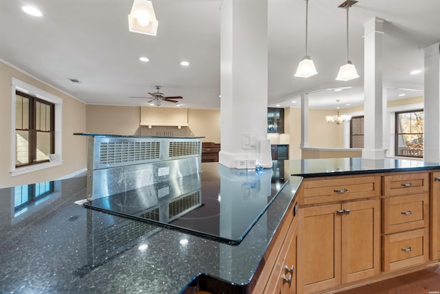 kitchen with recessed lighting, ceiling fan with notable chandelier, visible vents, dark stone countertops, and decorative light fixtures